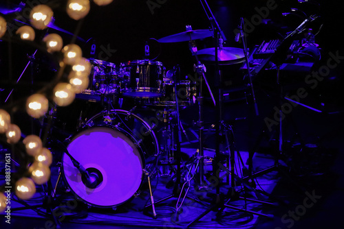 Sticker A drum set on the stage of a dimly lit live music venue before the show begins