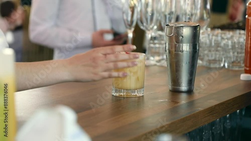 The bartender prepares a cocktail by adding strawberries and raspberries to a glass of drink. The concept of making cocktails.