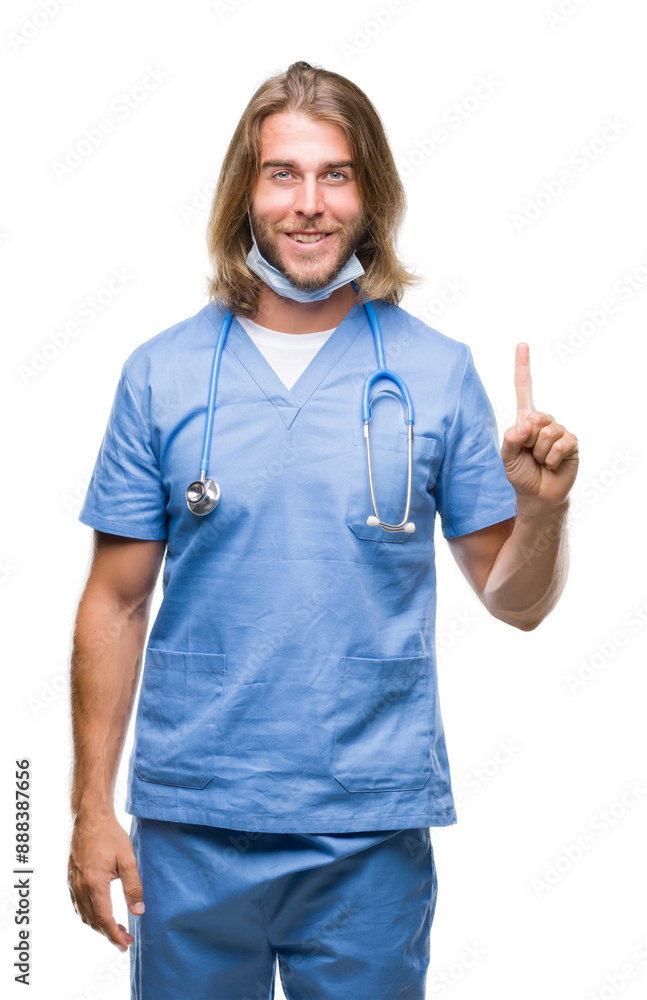 Young handsome doctor man with long hair over isolated background showing and pointing up with finger number one while smiling confident and happy. Young handsome doctor man with long hair over isolated background showing and pointing up with finger number one while smiling confident and happy.