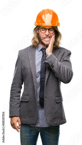 Young handsome architec man with long hair wearing safety helmet over isolated background touching mouth with hand with painful expression because of toothache or dental illness on teeth. 