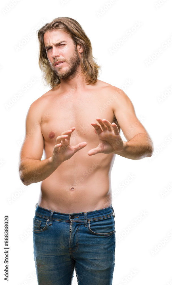Young handsome shirtless man with long hair showing sexy body over isolated background disgusted expression, displeased and fearful doing disgust face because aversion reaction. With hands raised. Young handsome shirtless man with long hair showing sexy body over isolated background disgusted expression, displeased and fearful doing disgust face because aversion reaction. With hands raised.