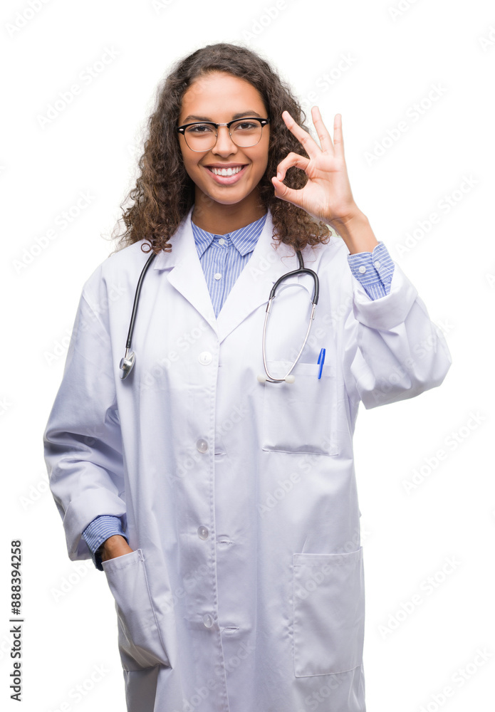 Young hispanic doctor woman doing ok sign with fingers, excellent symbol Young hispanic doctor woman doing ok sign with fingers, excellent symbol