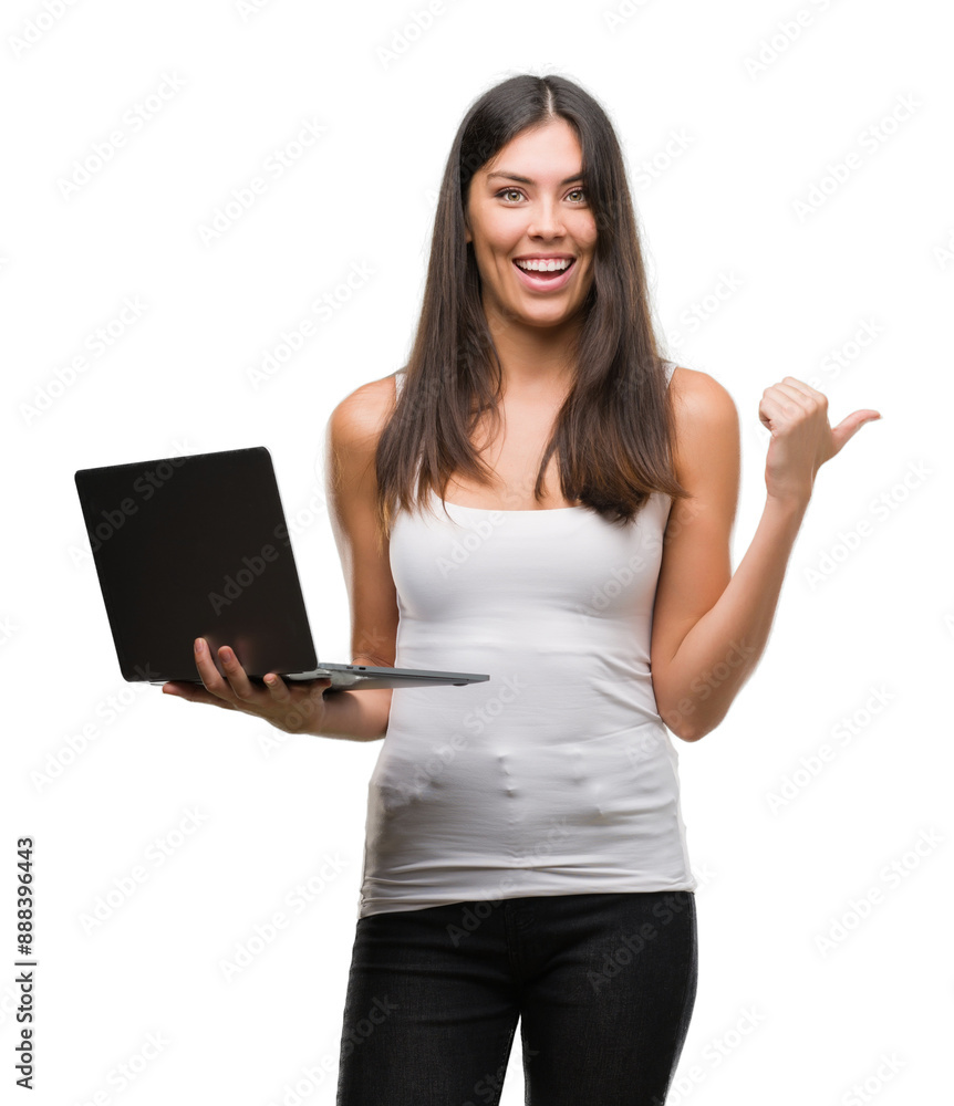 Young hispanic woman using computer laptop pointing and showing with thumb up to the side with happy face smiling Young hispanic woman using computer laptop pointing and showing with thumb up to the side with happy face smiling