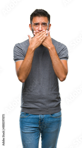 Adult hispanic man over isolated background shocked covering mouth with hands for mistake. Secret concept.