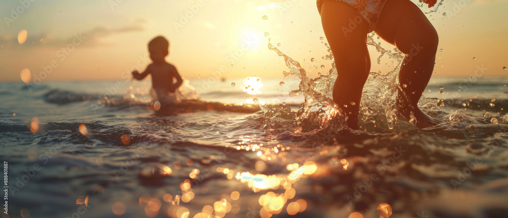 Fototapeta premium Children play gleefully in the shallow ocean waters at sunset, splashing and enjoying a carefree moment under the soft golden light.