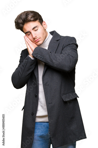 Young elegant man wearing winter coat over isolated background sleeping tired dreaming and posing with hands together while smiling with closed eyes.