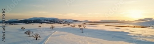 Serene winter landscape with snow-covered trees and hills under the setting sun, creating a tranquil and picturesque scene. © AbsoluteAI