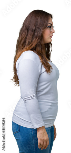 Beautiful plus size young woman over isolated background looking to side, relax profile pose with natural face with confident smile.
