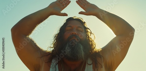 Bearded Man Practices Yoga During Sunset With Arms Raised