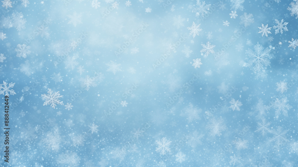 Fototapeta premium Light blue winter background with various white snowflakes and soft glowing particles