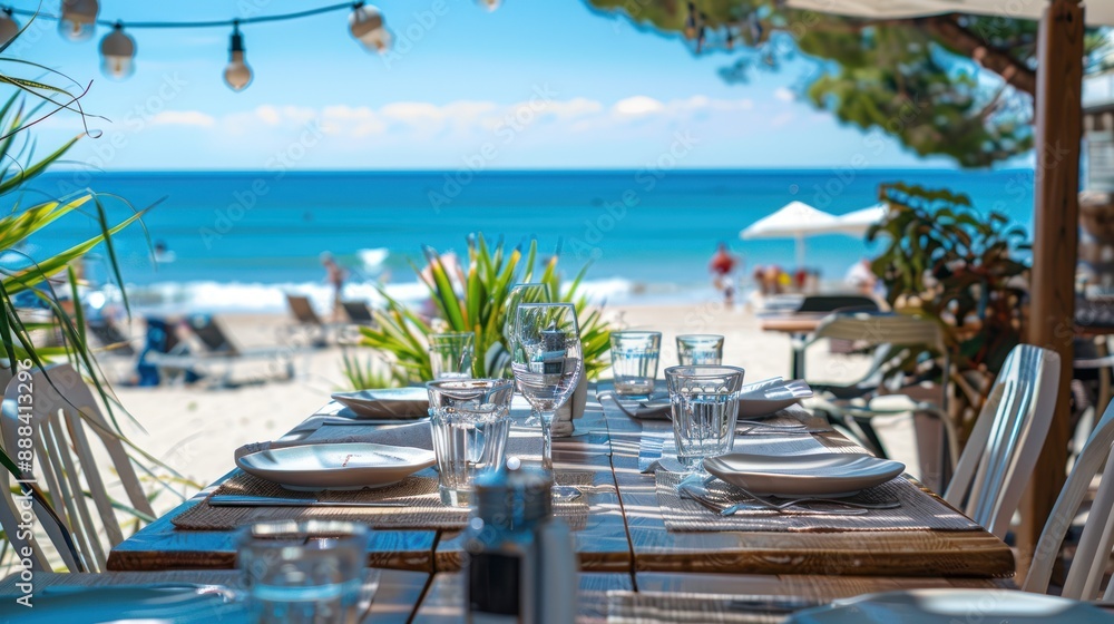 Fototapeta premium Beachfront Dining. Table set for lunch with an ocean view. Perfect for travel, restaurant, and vacation themes.