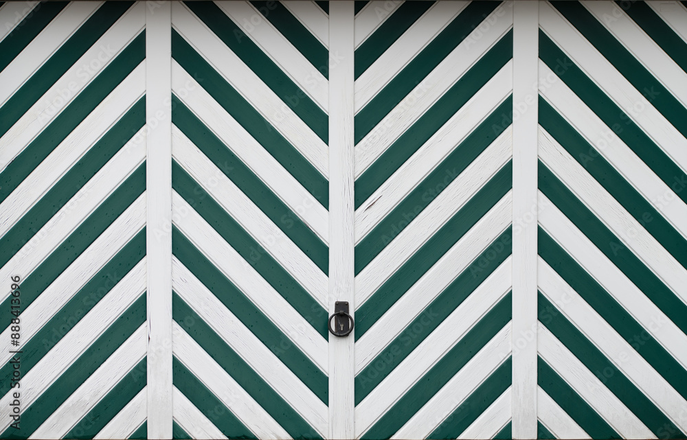 Background and texture of a wooden door, worked and painted in a herringbone pattern. The door is painted white and green. The door is closed. Background and texture of a wooden door, worked and painted in a herringbone pattern. The door is painted white and green. The door is closed.