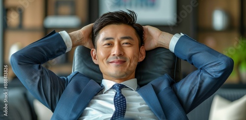 Smiling Businessman Relaxing in Office Chair During Daytime