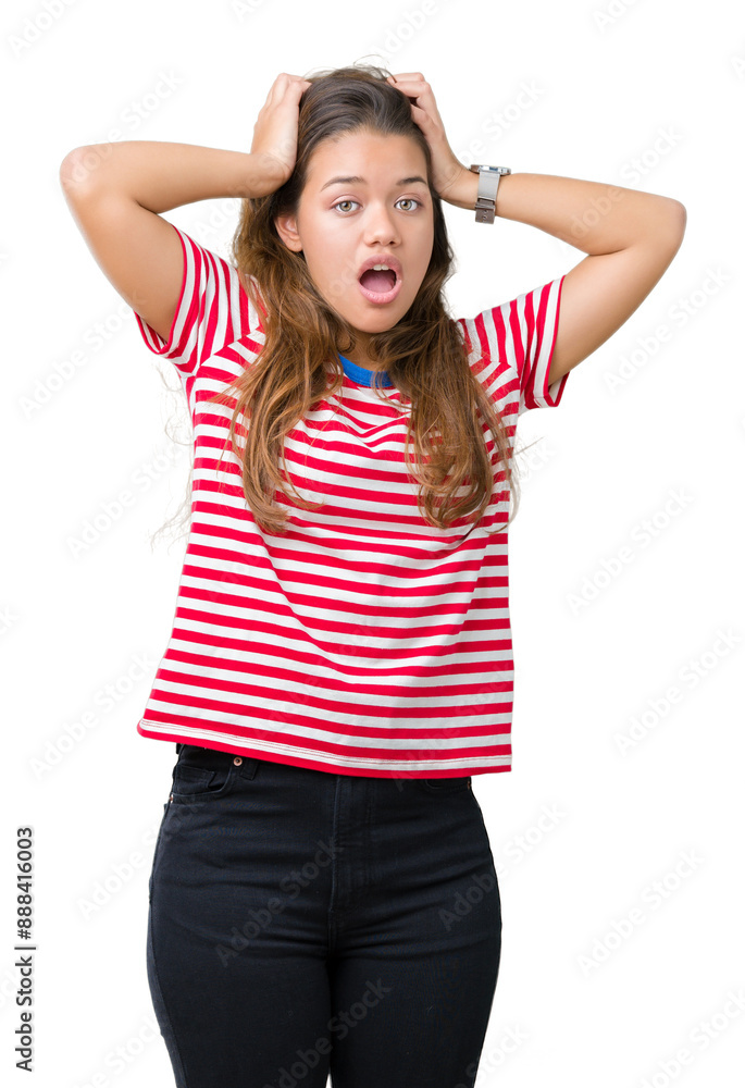Young beautiful brunette woman wearing stripes t-shirt over isolated background Crazy and scared with hands on head, afraid and surprised of shock with open mouth Young beautiful brunette woman wearing stripes t-shirt over isolated background Crazy and scared with hands on head, afraid and surprised of shock with open mouth