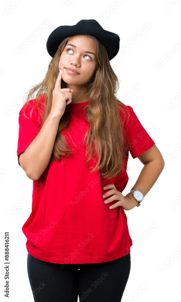 Young beautiful brunette fashion woman wearing red t-shirt and black beret over isolated background with hand on chin thinking about question, pensive expression. Smiling with thoughtful face. Young beautiful brunette fashion woman wearing red t-shirt and black beret over isolated background with hand on chin thinking about question, pensive expression. Smiling with thoughtful face.
