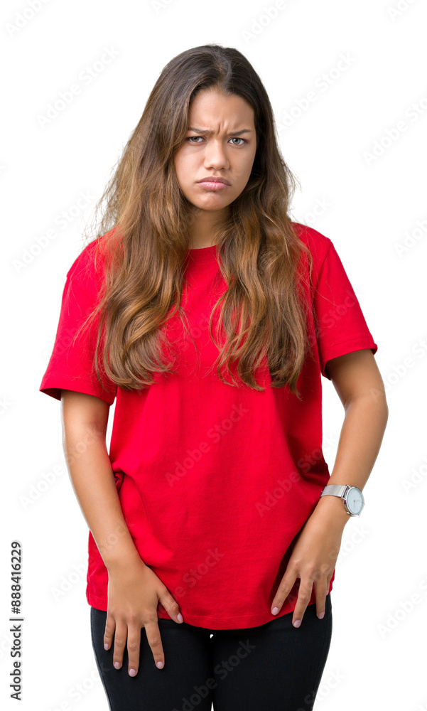 Young beautiful brunette woman wearing red t-shirt over isolated background skeptic and nervous, frowning upset because of problem. Negative person. Young beautiful brunette woman wearing red t-shirt over isolated background skeptic and nervous, frowning upset because of problem. Negative person.