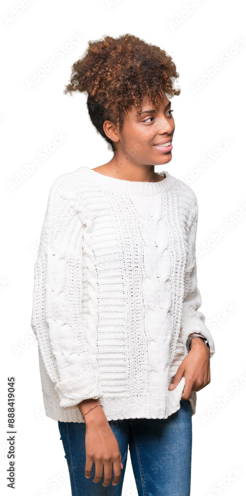 Beautiful young african american woman wearing winter sweater over isolated background looking away to side with smile on face, natural expression. Laughing confident. Beautiful young african american woman wearing winter sweater over isolated background looking away to side with smile on face, natural expression. Laughing confident.