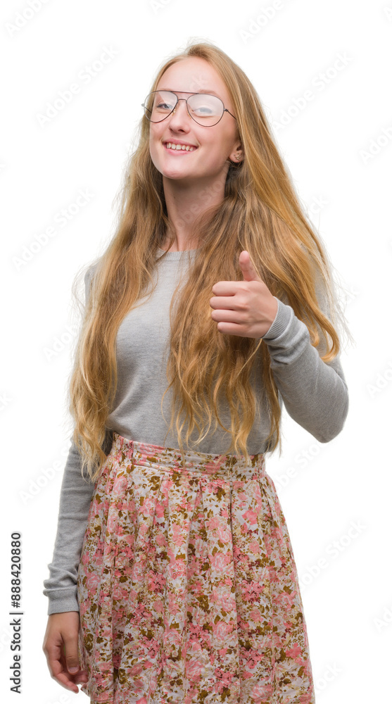 Φωτογραφία Blonde teenager woman wearing flowers skirt doing happy thumbs up gesture with hand