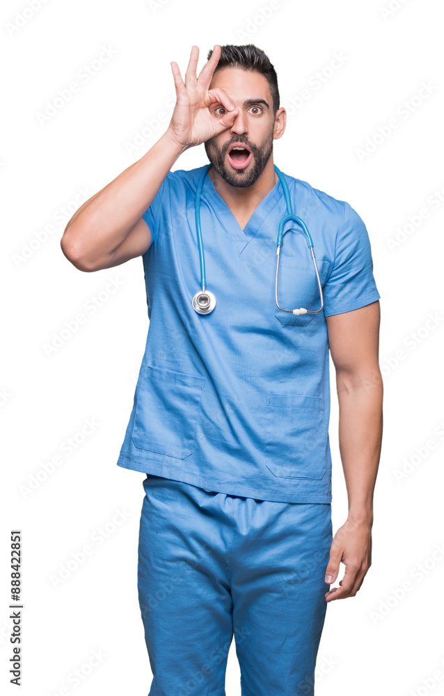 Handsome young doctor surgeon man over isolated background doing ok gesture shocked with surprised face, eye looking through fingers. Unbelieving expression. Handsome young doctor surgeon man over isolated background doing ok gesture shocked with surprised face, eye looking through fingers. Unbelieving expression.