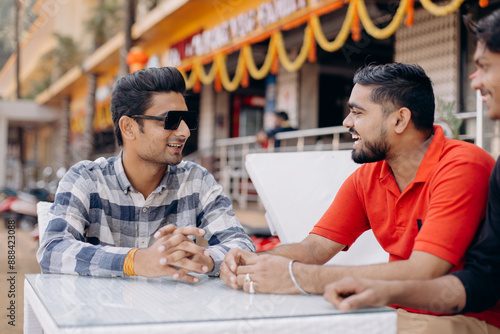 Friends Enjoying Conversation at Outdoor Caf on a Sunny Day photo