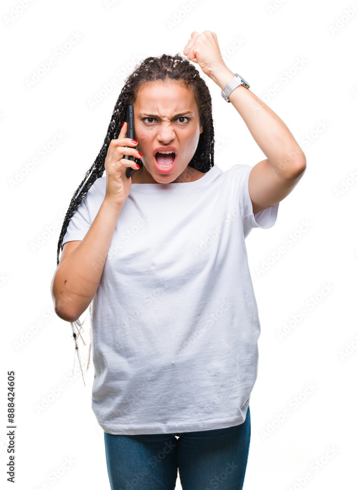 Young braided hair african american girl showing calling using smartphone over isolated background annoyed and frustrated shouting with anger, crazy and yelling with raised hand, anger concept Young braided hair african american girl showing calling using smartphone over isolated background annoyed and frustrated shouting with anger, crazy and yelling with raised hand, anger concept