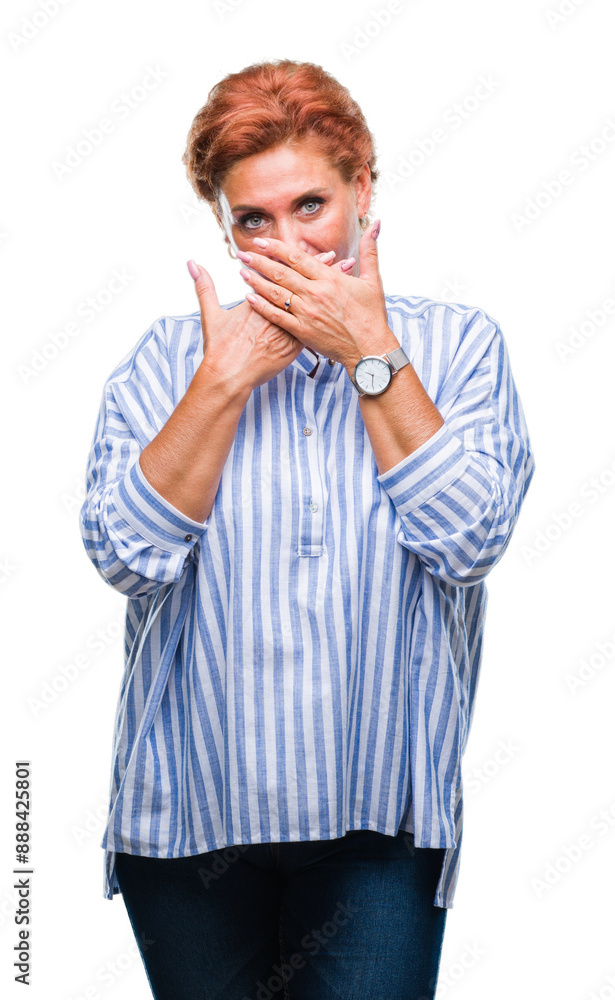 Atrractive senior caucasian redhead woman over isolated background shocked covering mouth with hands for mistake. Secret concept.