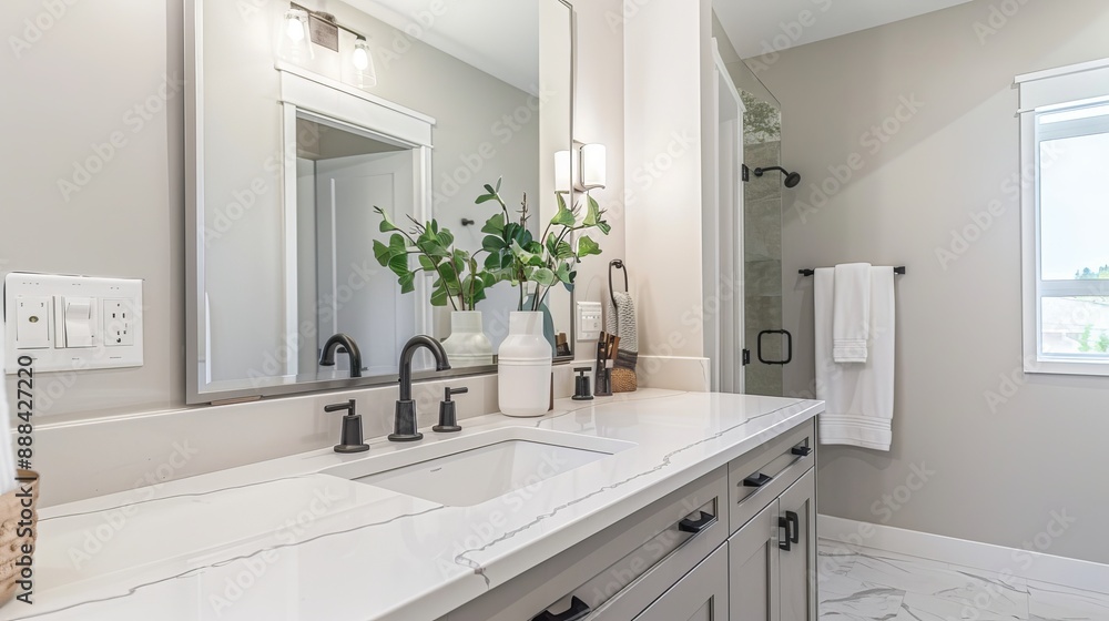 A bathroom vanity with a sink, faucet, and mirror. A bathroom vanity with a sink, faucet, and mirror.