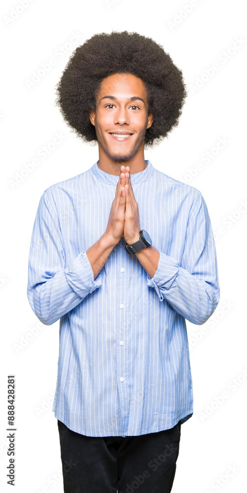 Young african american man with afro hair praying with hands together asking for forgiveness smiling confident. Young african american man with afro hair praying with hands together asking for forgiveness smiling confident.