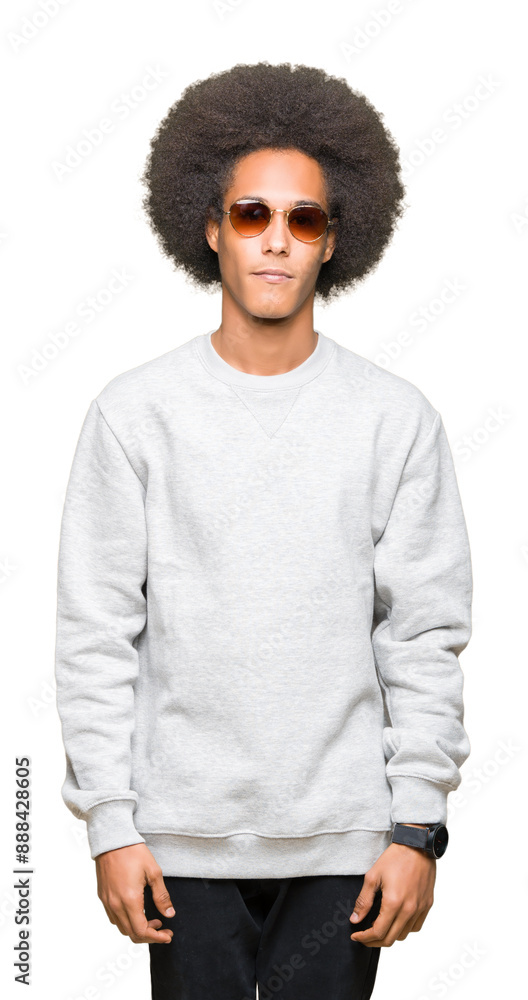 Young african american man with afro hair wearing sunglasses with serious expression on face. Simple and natural looking at the camera. Young african american man with afro hair wearing sunglasses with serious expression on face. Simple and natural looking at the camera.
