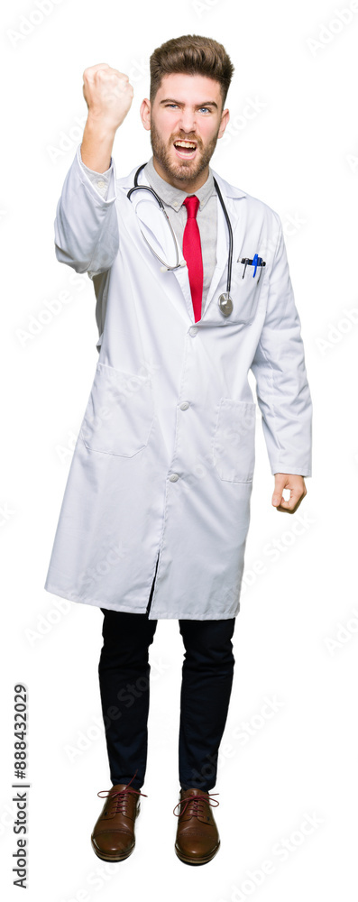 Young handsome doctor man wearing medical coat angry and mad raising fist frustrated and furious while shouting with anger. Rage and aggressive concept. Young handsome doctor man wearing medical coat angry and mad raising fist frustrated and furious while shouting with anger. Rage and aggressive concept.