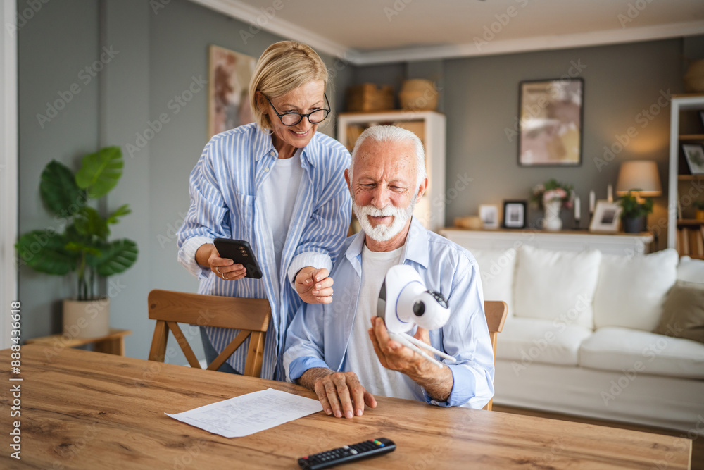 Fototapeta premium senior couple connect, adjust cctv security surveillance camera