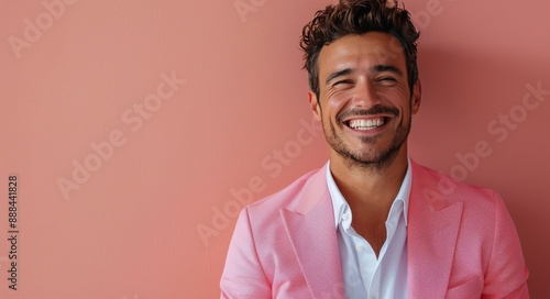 Portrait of a Smiling Man Wearing a Pink Blazer Against a Pink Wall