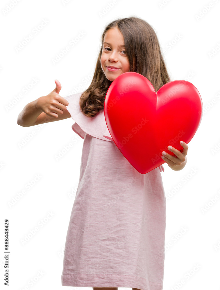 Brunette hispanic girl holding red heart happy with big smile doing ok sign, thumb up with fingers, excellent sign Brunette hispanic girl holding red heart happy with big smile doing ok sign, thumb up with fingers, excellent sign