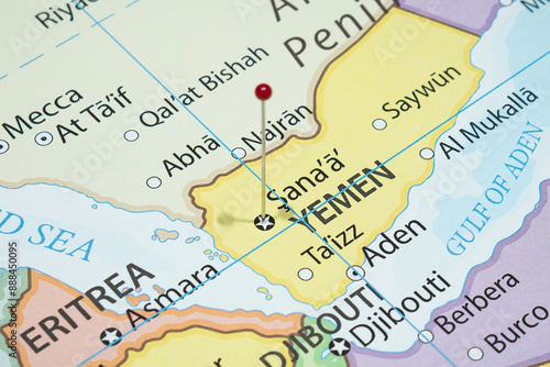 Close up to a Sanaa city with a red pin needle into Yemen country political map 