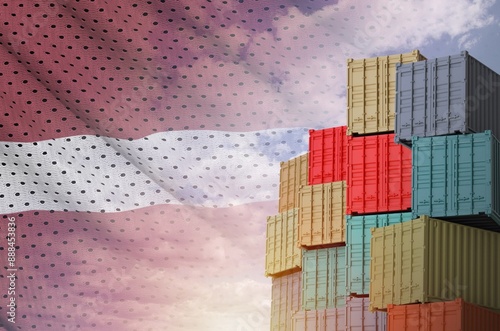 Latvia flag and big stack of shipping cargo containers in docks with sky background close up photo