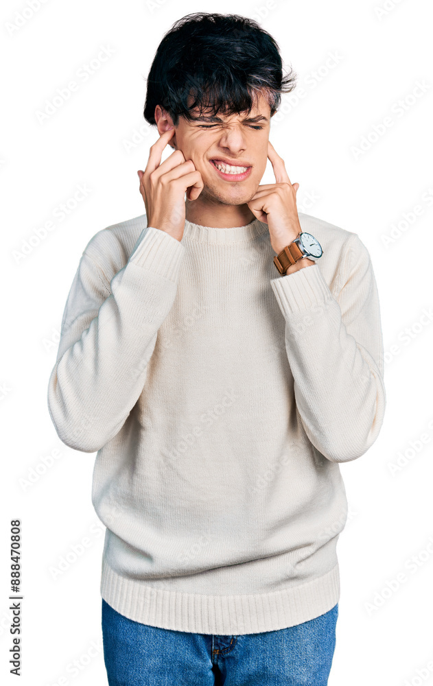 Handsome hipster young man wearing casual winter sweater covering ears with fingers with annoyed expression for the noise of loud music. deaf concept. Handsome hipster young man wearing casual winter sweater covering ears with fingers with annoyed expression for the noise of loud music. deaf concept.