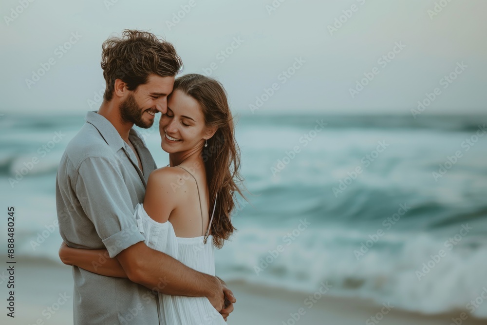 Romantic couple embracing on beach with ocean waves in background happiness love concept Romantic couple embracing on beach with ocean waves in background happiness love concept