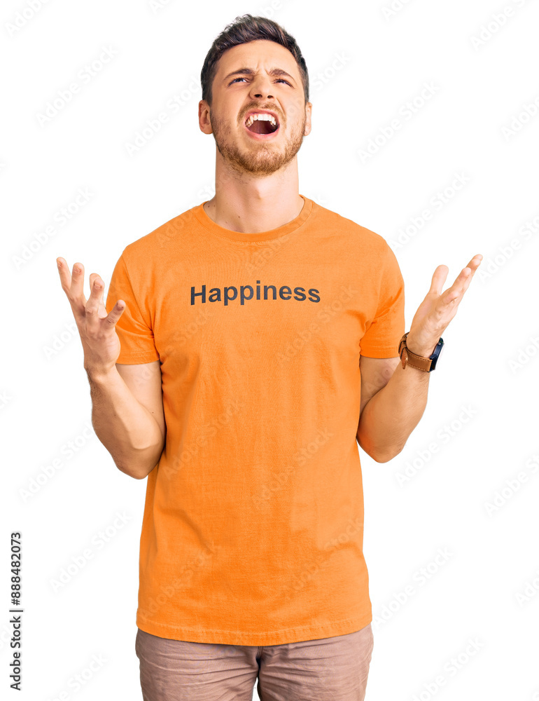 Handsome young man with bear wearing tshirt with happiness word message crazy and mad shouting and yelling with aggressive expression and arms raised. frustration concept. Handsome young man with bear wearing tshirt with happiness word message crazy and mad shouting and yelling with aggressive expression and arms raised. frustration concept.