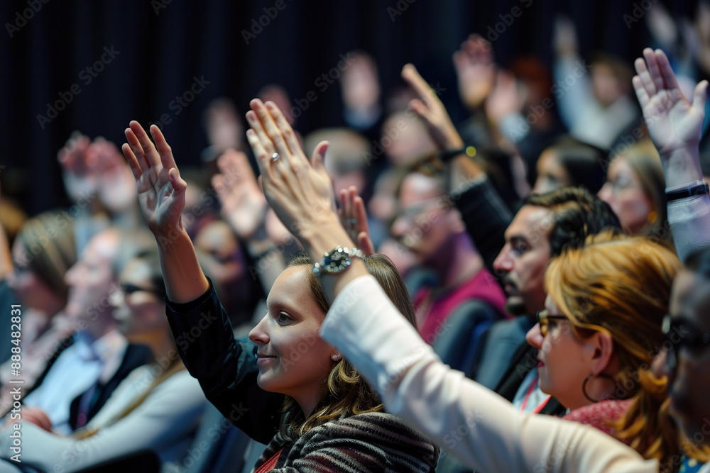 Fototapeta premium A group of people are in a room, all raising their hands in unison