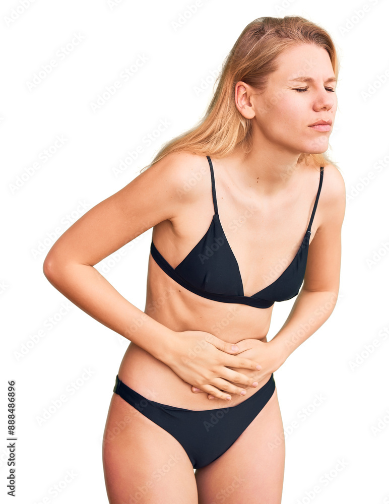 Fototapeta premium Young beautiful blonde woman wearing bikini with hand on stomach because indigestion, painful illness feeling unwell. ache concept.