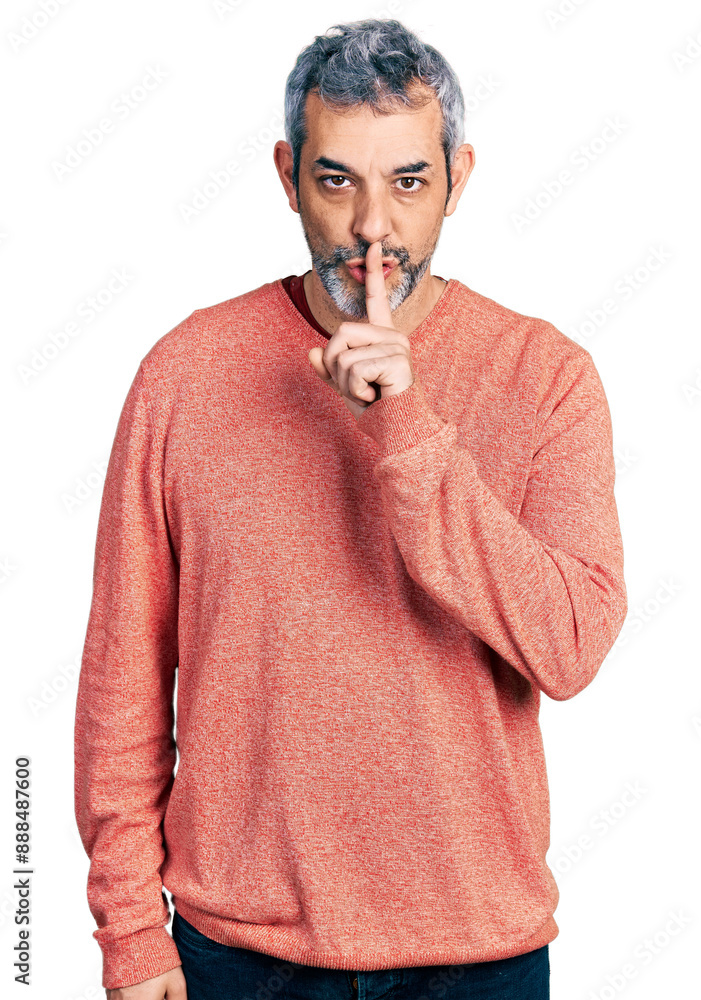Middle age hispanic with grey hair wearing casual sweater asking to be quiet with finger on lips. silence and secret concept. Middle age hispanic with grey hair wearing casual sweater asking to be quiet with finger on lips. silence and secret concept.