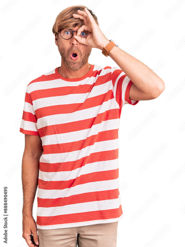 Handsome caucasian man with beard wearing casual clothes and glasses doing ok gesture shocked with surprised face, eye looking through fingers. unbelieving expression. Handsome caucasian man with beard wearing casual clothes and glasses doing ok gesture shocked with surprised face, eye looking through fingers. unbelieving expression.