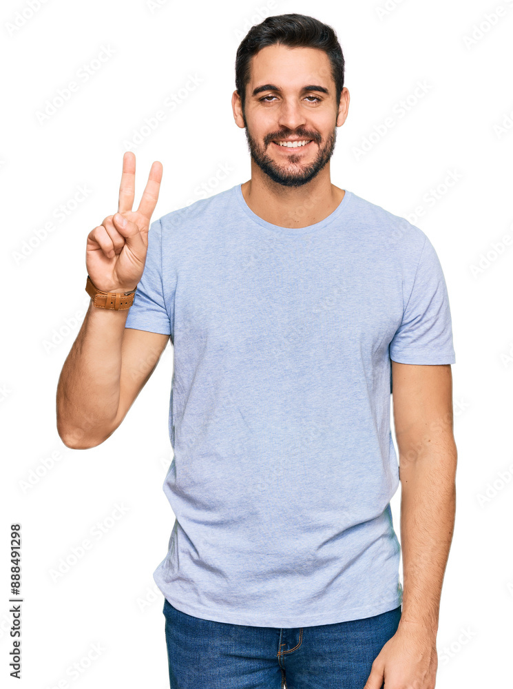 Young hispanic man wearing casual clothes showing and pointing up with fingers number two while smiling confident and happy. Young hispanic man wearing casual clothes showing and pointing up with fingers number two while smiling confident and happy.