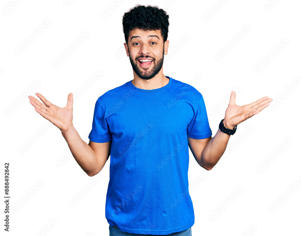 Young arab man with beard wearing casual blue t shirt celebrating crazy and amazed for success with arms raised and open eyes screaming excited. winner concept Young arab man with beard wearing casual blue t shirt celebrating crazy and amazed for success with arms raised and open eyes screaming excited. winner concept