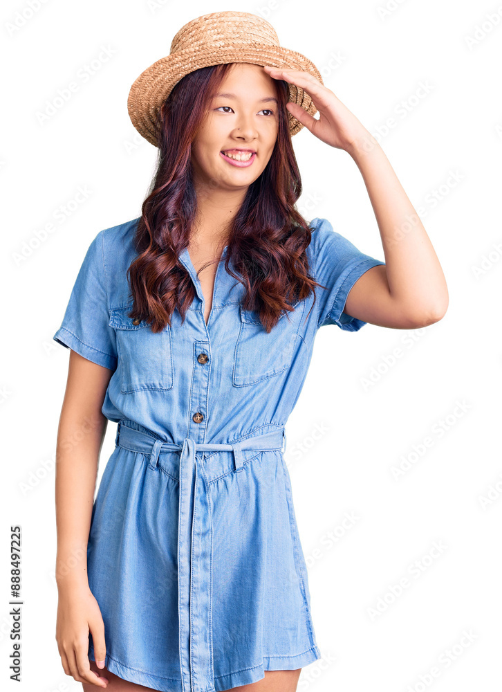 Young beautiful chinese girl wearing summer hat smiling confident touching hair with hand up gesture, posing attractive and fashionable Young beautiful chinese girl wearing summer hat smiling confident touching hair with hand up gesture, posing attractive and fashionable