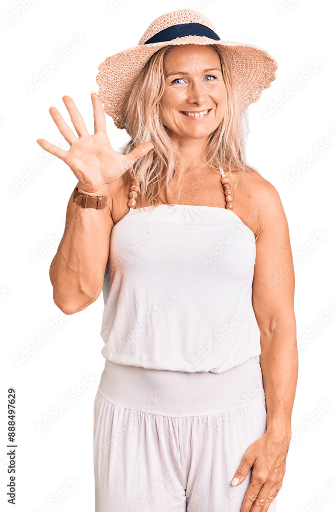 Middle age fit blonde woman wearing summer hat showing and pointing up with fingers number five while smiling confident and happy. Middle age fit blonde woman wearing summer hat showing and pointing up with fingers number five while smiling confident and happy.