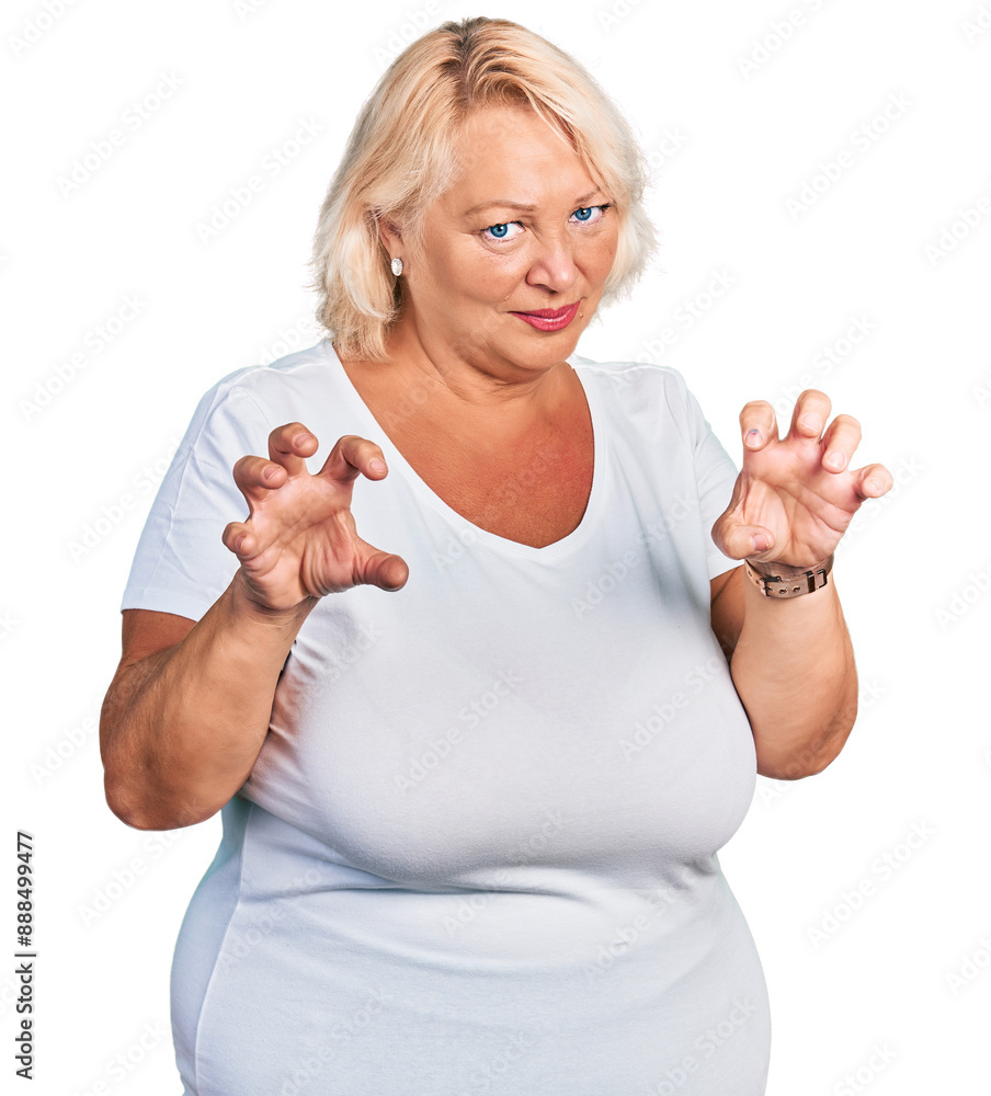 Middle age blonde woman wearing casual white t shirt smiling funny doing claw gesture as cat, aggressive and sexy expression Middle age blonde woman wearing casual white t shirt smiling funny doing claw gesture as cat, aggressive and sexy expression