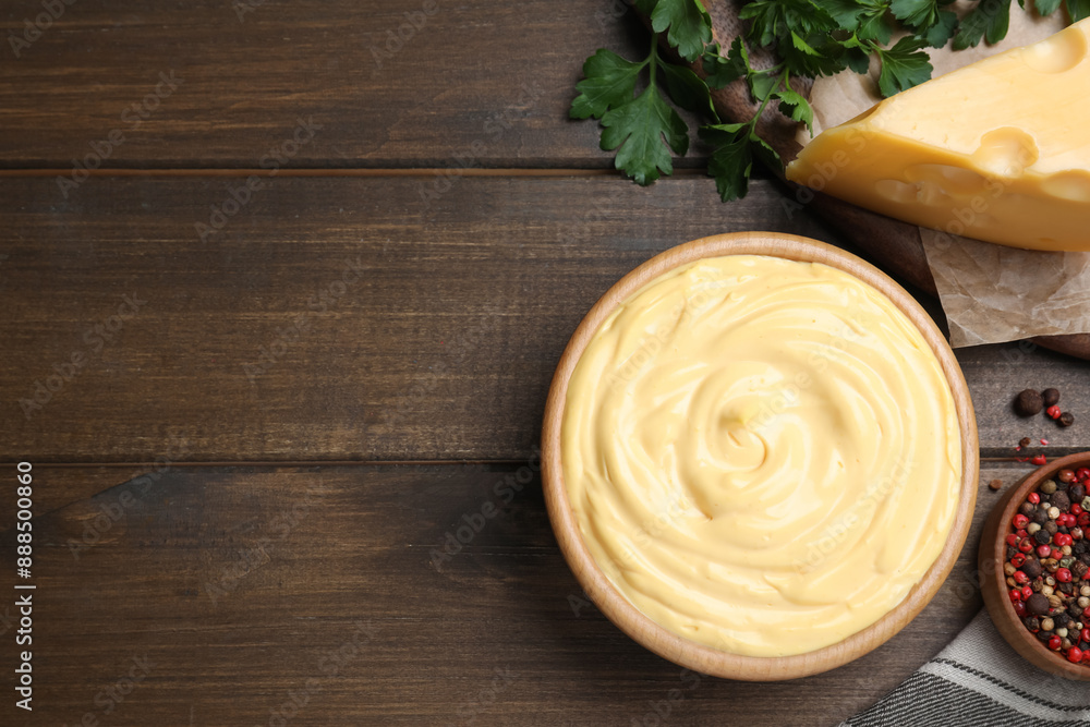 Tasty cheese sauce, pepper and parsley on wooden table, flat lay. Space for text Tasty cheese sauce, pepper and parsley on wooden table, flat lay. Space for text