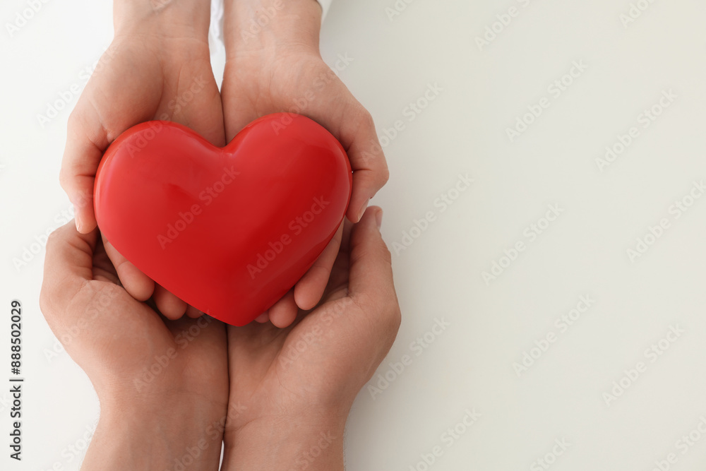 Fototapeta premium Doctor and patient holding red heart on white background, top view. Space for text