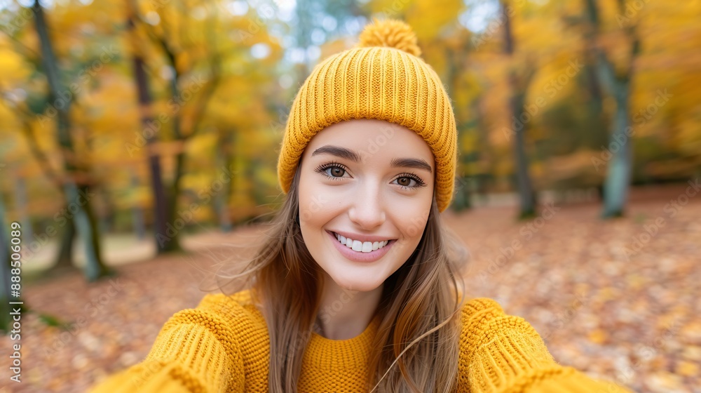 Young Woman Enjoying Autumn Day in Park with Cozy Yellow Sweater and Beanie Young Woman Enjoying Autumn Day in Park with Cozy Yellow Sweater and Beanie